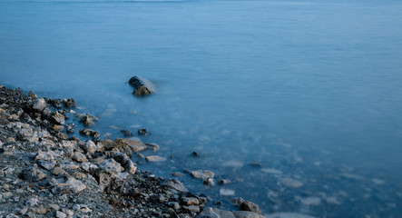 post card concept background landscape rocky coast line long exposure photography scenic view lonely stone in water peaceful surface wallpaper pattern empty copy space for your text here