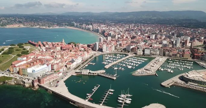Panoramic aerial view of Gijon on Atlantic ocean coast overlooking of marina with moored pleasure yachts, Spain
