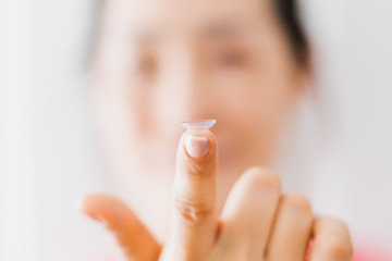 Naklejka premium Beautiful Woman Putting Eye Lenses With Hands