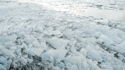 Aerial view of a frozen river. Fancy ice texture, cold chained water. Shards of ice stick out with sharp edges.