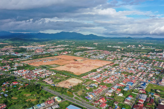 Aerial view of the wild river with the old wooden bridge connecting between two mainland in Kampung Imbak, Tongod, Sabah, Malaysia, Borneo.
