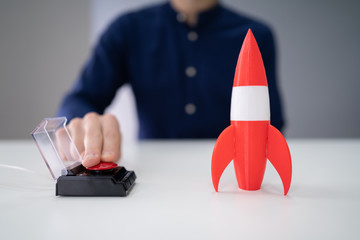 Businessman's Hand Launching Rocket