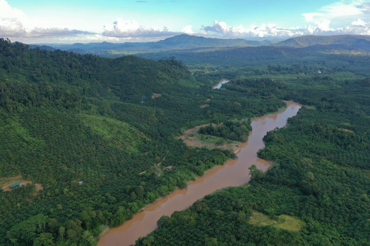 Aerial view of the wild river with the old wooden bridge connecting between two mainland in Kampung Imbak, Tongod, Sabah, Malaysia, Borneo.