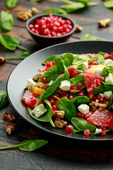 Orange Grapefruit salad with spinach, walnuts, pomegranate seeds and feta cheese. healthy food
