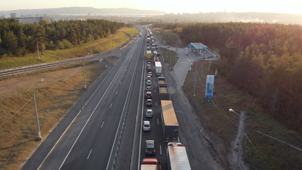 aerial view. Intercity highway section. Congestion on the road. Cars and wagons are standing in a long traffic jam. Slow moving vehicle.