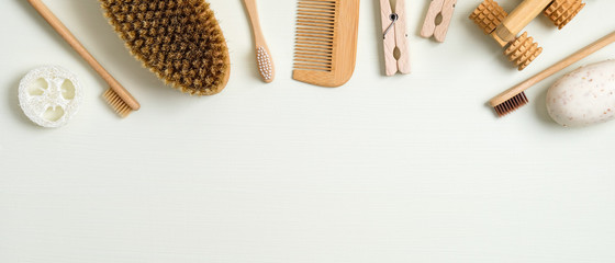 Zero waste bathroom accessories on green background. Frame border of luffa sponge, massage brush,...