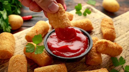 Homemade Potato Croquettes with dipping sauce on wooden board