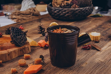 In a traditional Asian style, a black stone bowl holds a health stock made from goji berries, ginger, tripe and lobster.