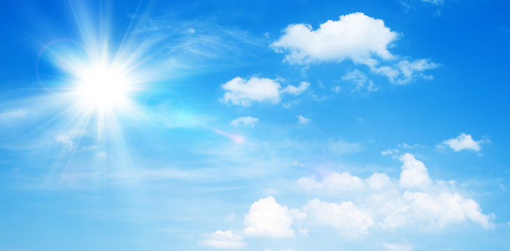 Sunny natural background, blue sky with sun and white clouds.