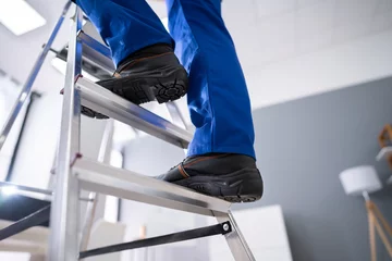 Deurstickers Handyman Climbing Ladder © Andrey Popov