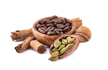 Coffee beans with cardamon and cinnamon  isolated on white background. Coffee beans with spices.