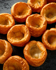 Traditional English Yorkshire pudding side dish on black rustic background