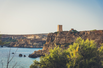 Fototapeta na wymiar Ancient tower on the rock on the sea border