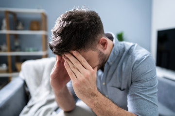 Man Suffering From Headache At Home