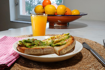 Toast with avocado, chili flakes, . and juice