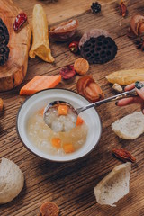 with mushrooms, scallions, shrimp, garlic, eggs, carrots to make a bowl of beauty porridge. 