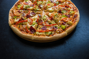homemade delicious pizza on dark background close up