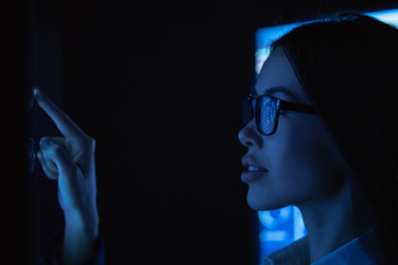 The young business woman touches sensor surface