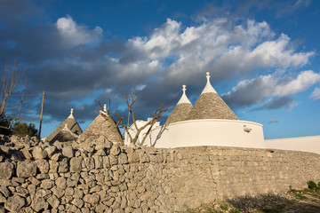 typical houses in the Apulian countryside and a sky with clouds