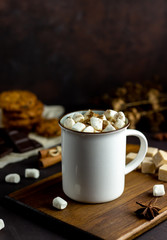 Hot chocolate with marshmallows in a white mug on a rusty background. Winter. Recipes.