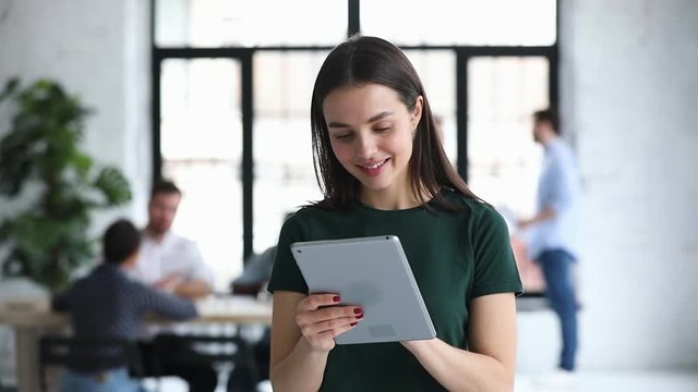 Young businesswoman professional using digital tablet standing in office