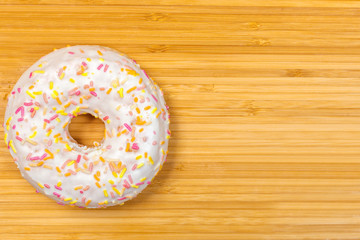 Glazed donut on a bamboo Board background