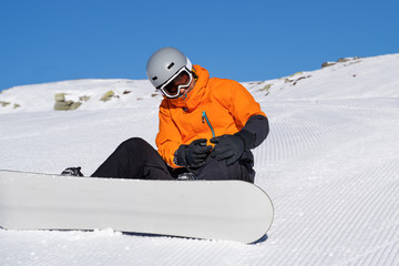 Snowboarder Looking At His Injured Knee