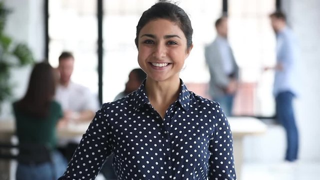 Smiling professional indian businesswoman hr looking extending hand to camera