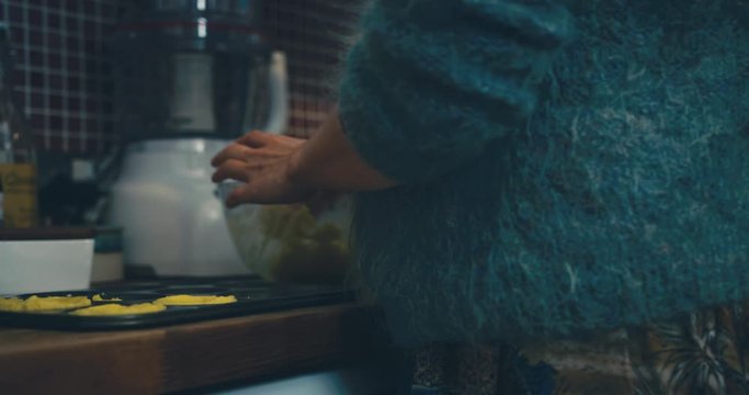 Young woman preparing cookies for the oven