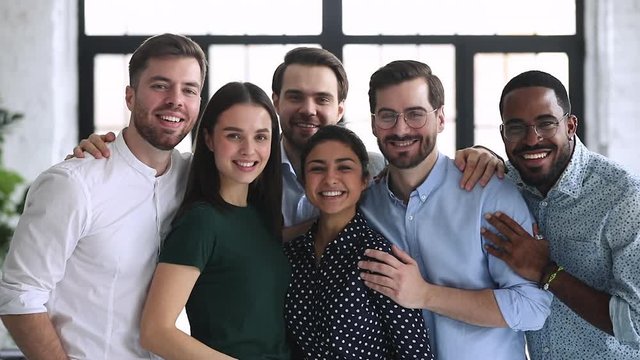 Happy professional diverse team business people bonding stand in office