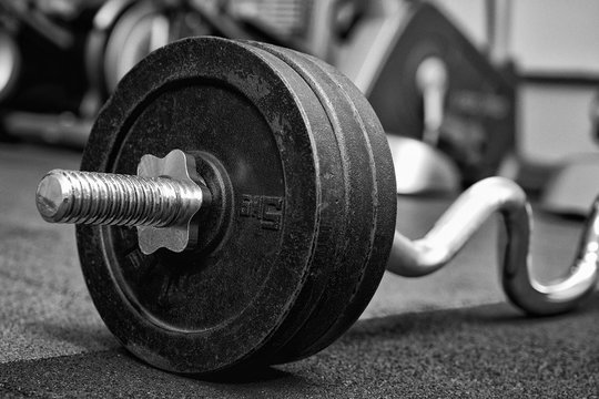 Closeup image of barbell dumbbell fitness equipment in gym