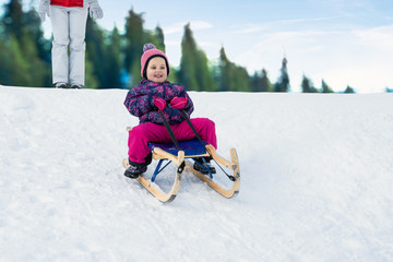 Kid Sliding With Sledge In The Snow
