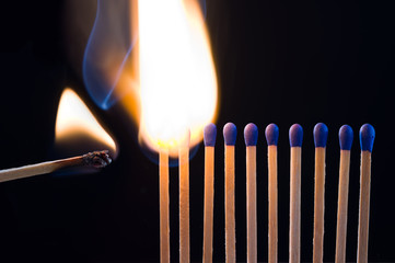 Burning match ignites other matchsticks