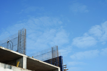  tower cranes against the sky. Yellow construction cranes on a background of blue sky. 