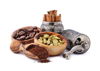 Coffee beans with cardamon and cinnamon  isolated on white background. Coffee beans with spices.