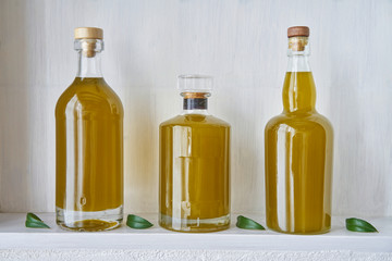 detail olive oil bottle bottles oils three living gold food cooking natural organic beauty  country house healthy stylish white leef green kitchen shelf closeup