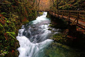 Rapids in the canyon with the footbridge of the Kamačnik River in autumn, Croatia