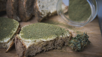 Close-up of bread with hemp flour, sandwich with cannabis butter and hashish - obrazy, fototapety, plakaty