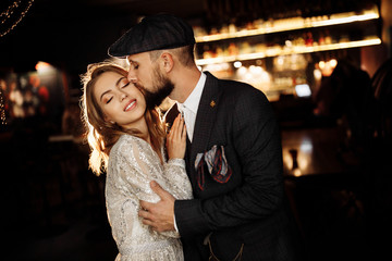 Attractive couple near the bar with beautiful light 