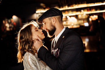 Attractive couple near the bar with beautiful light 