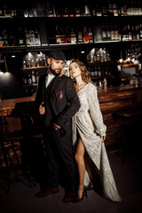 Attractive couple near the bar with beautiful light 