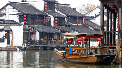 Fototapeta na wymiar Zhujiajiao Water Town and China traditional tourist boats on canals of Shanghai Zhujiajiao Water Town in Shanghai, China.