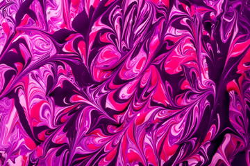 Abstract background of pink, purple and black paint swirls