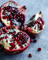 Three pieces of pomegranate on blue background