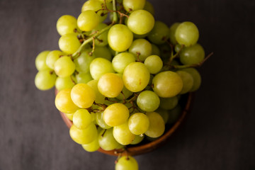 Green grapes in the wooden bowl