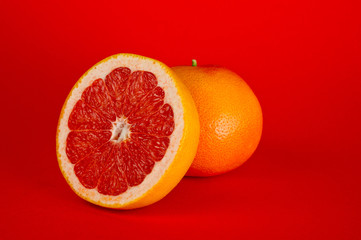 Grapefruit ripe and juicy and healthy, shot large on a red background