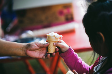 The hands of the poor handed a plate to receive food from volunteers to alleviate hunger, the...