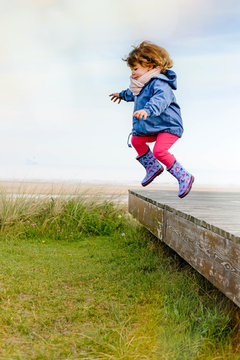 cute little girl jumping in nature