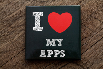 I Love My Apps written on black note with wood background