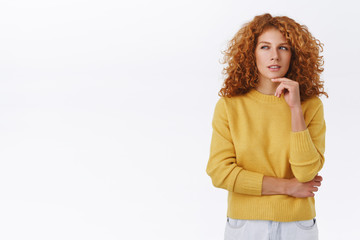 Suspicious and thoughtful, smart redhead curly woman have doubts, thinking, pondering important decision, touching chin and squinting as stare left, have assumptions, white background